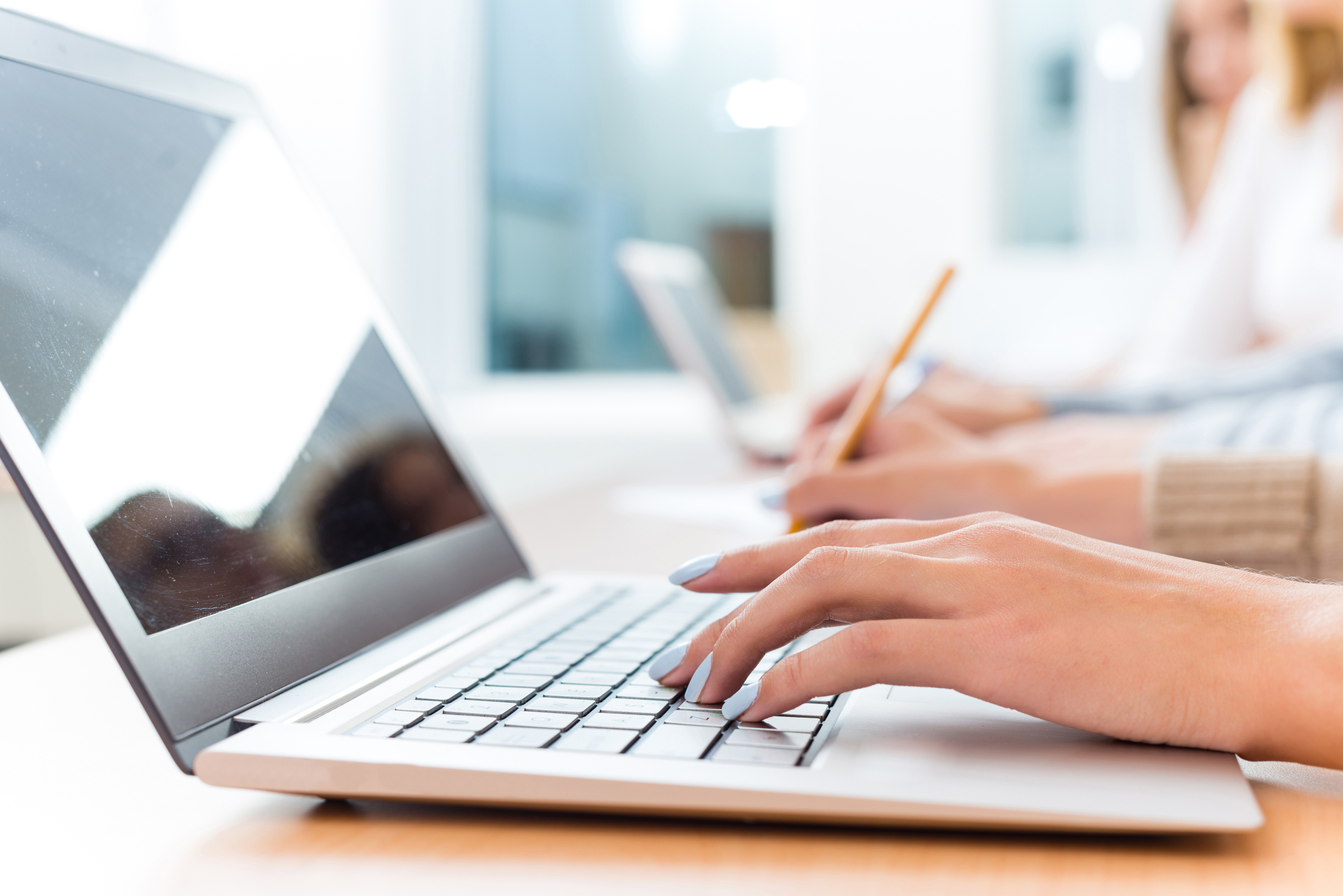 close up of female hands on the laptop keyboard